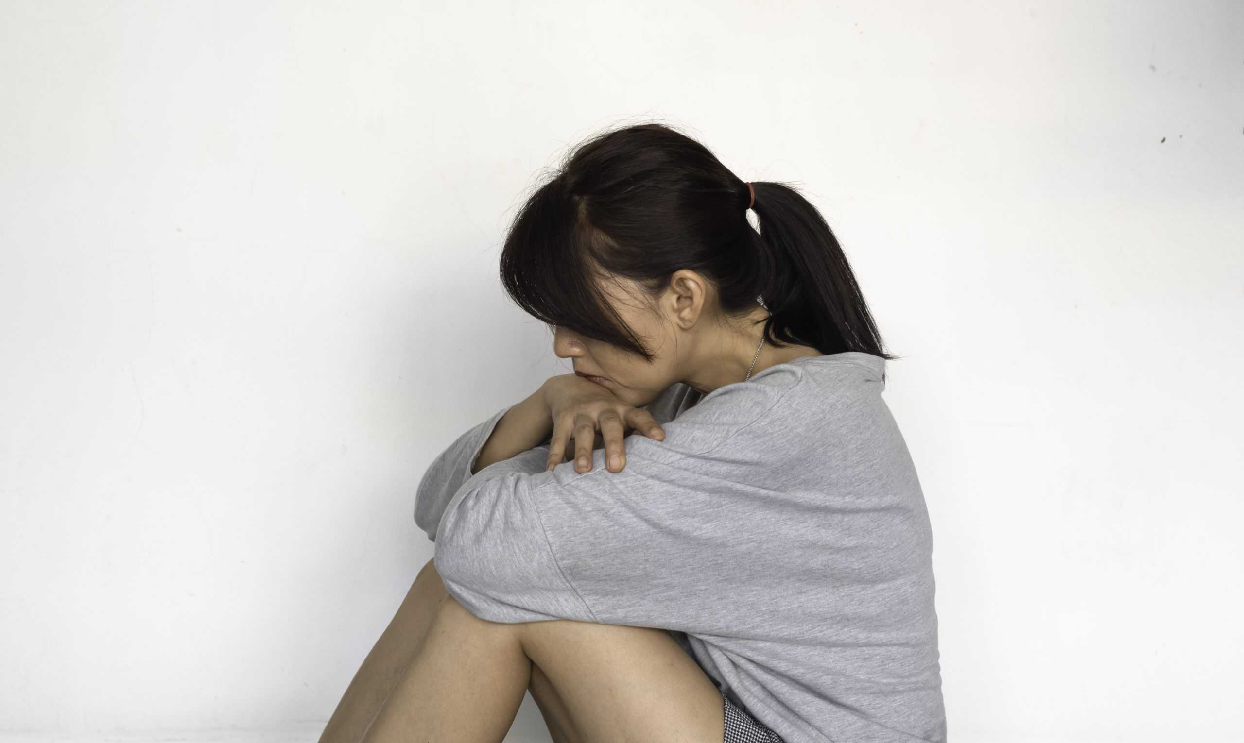 unhappy-woman-sits-and-hugs-her-knees-up-to-the-chest-with-upset-and-sad-feeling-scaled
